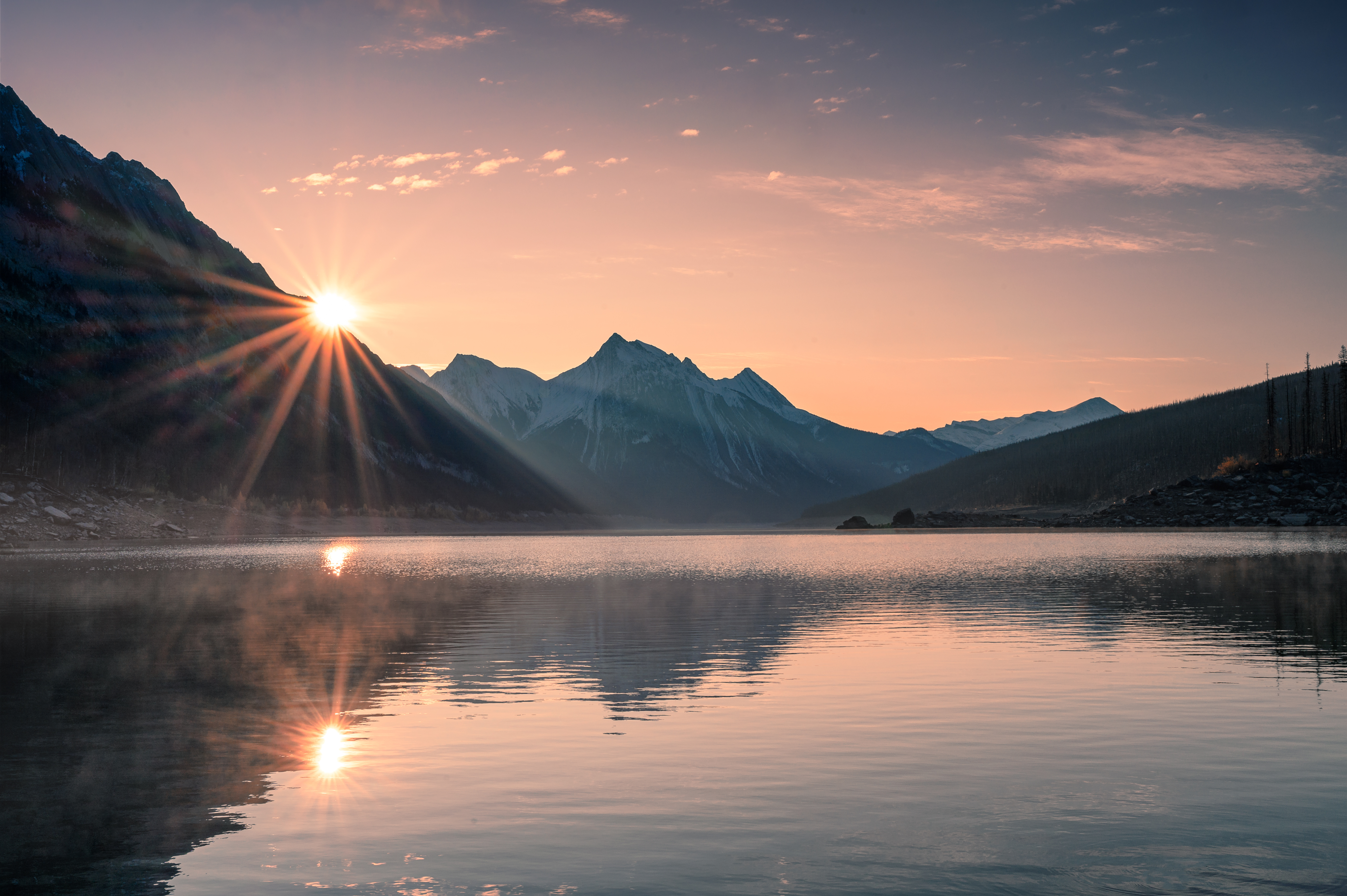 A view of lakes and mountains at dusk