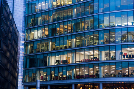 A view of office workers from the outside of a building